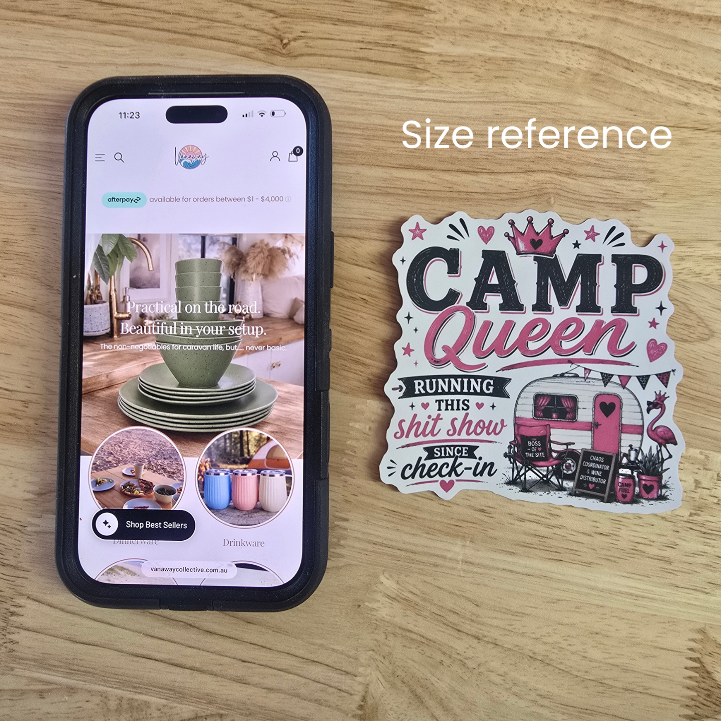 Size reference showing a Vanaway Camp Queen caravan vinyl sticker beside a smartphone to demonstrate the sticker's dimensions.