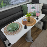 Vanaway Speckled Matcha rPET caravan dinnerware set styled on a caravan dining table with woven placemats, insulated wine tumblers, decorative cushions and a pothos plant. asymmetrical dinnerware