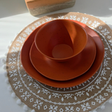 Vanaway Speckled Spice rPET caravan dinnerware place setting featuring a dinner plate, side plate and bowl stacked together, showcasing the warm terracotta speckled finish and modern nesting design. asymmetrical dinnerware