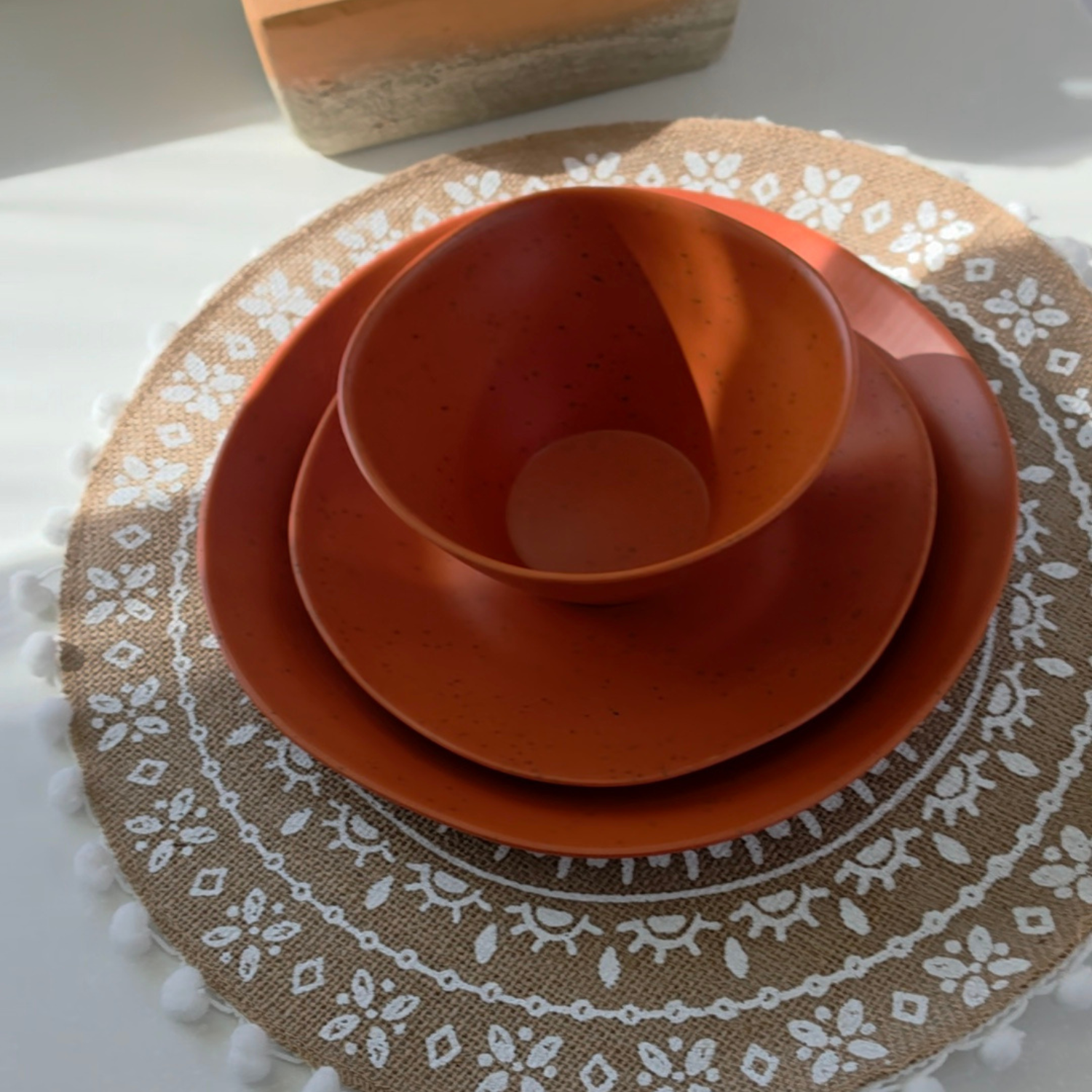 Vanaway Speckled Spice rPET caravan dinnerware place setting featuring a dinner plate, side plate and bowl stacked together, showcasing the warm terracotta speckled finish and modern nesting design. asymmetrical dinnerware
