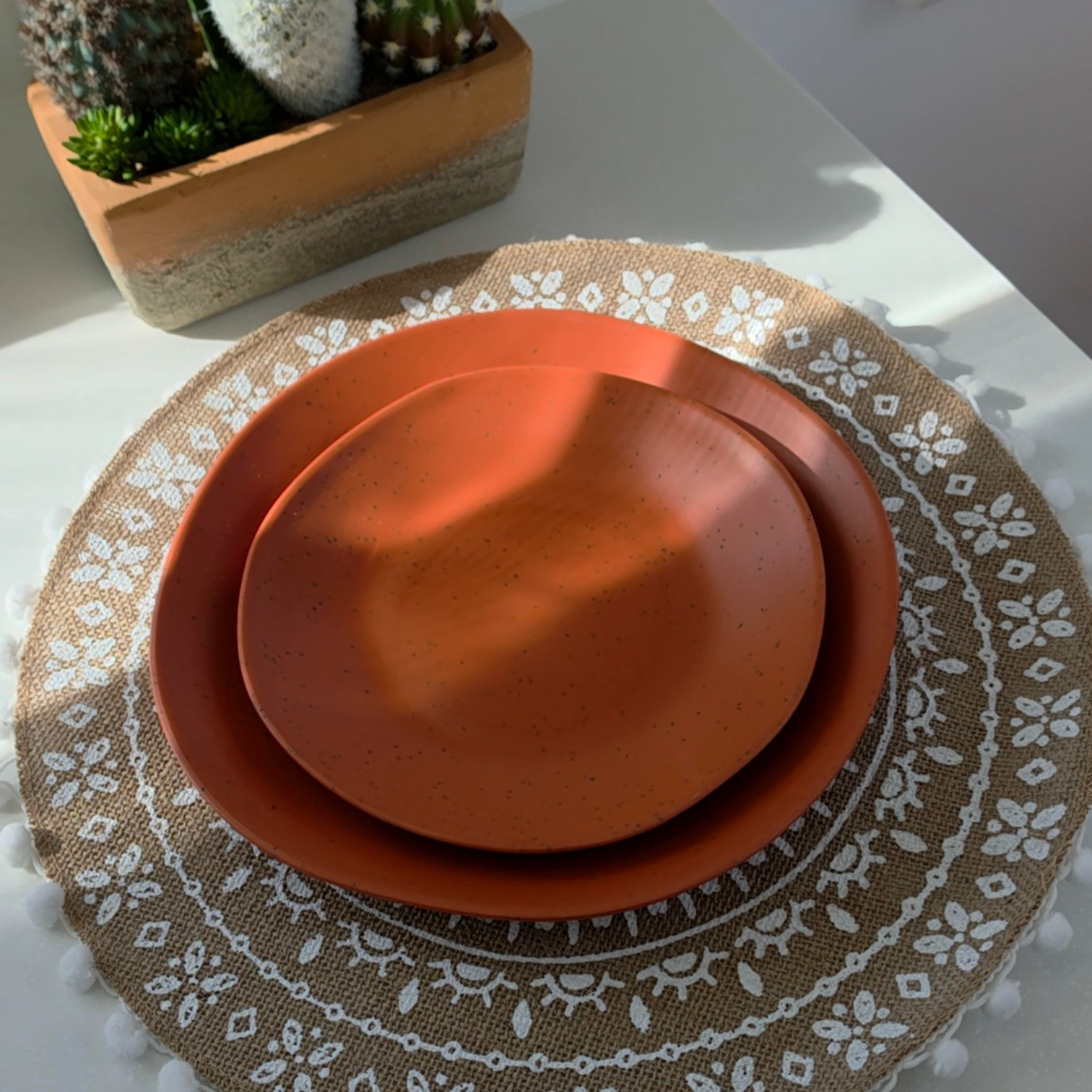 Vanaway Speckled Spice rPET caravan dinner plate and side plate stacked together, showcasing the warm terracotta speckled finish and lightweight design. asymmetrical dinnerware