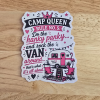 A die-cut sticker with a whimsical 'Camp Queen' design, featuring pink flamingos, a retro camper van, and text reading 'CAMP QUEEN RULE NO. 5: Do the hanky panky.
