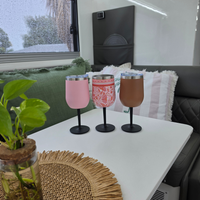 Three Vanaway insulated stainless steel wine tumblers with removable screw-on stems in Blush Pink, Pink Floral and Retro Brown, displayed on a caravan table.
