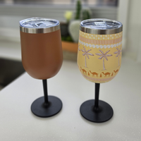 Vanaway insulated stainless steel wine tumblers with removable screw-on stems in Retro Brown and Golden Palms, displayed side by side to showcase the plain and printed designs.