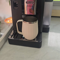 Coffee machine dispensing a cup of coffee on a countertop of caravan