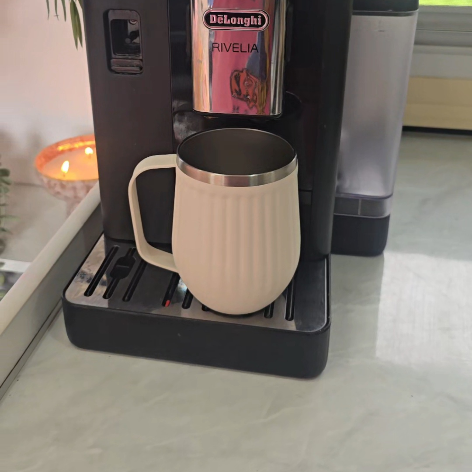 Coffee machine dispensing a cup of coffee on a countertop of caravan