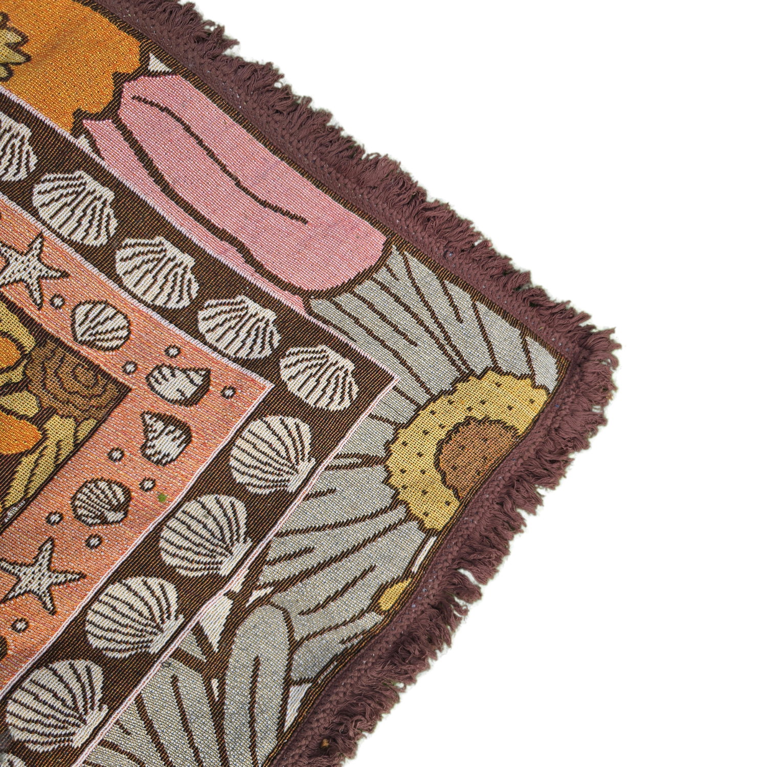 Close-up of the Vanaway Sunblossom woven travel throw rug corner, showcasing the floral border, woven texture and soft fringe detail.