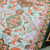 Detailed view of the Vanaway Willow woven travel throw rug highlighting its soft blue, sage green, cream and terracotta botanical design, intricate woven texture and premium craftsmanship.