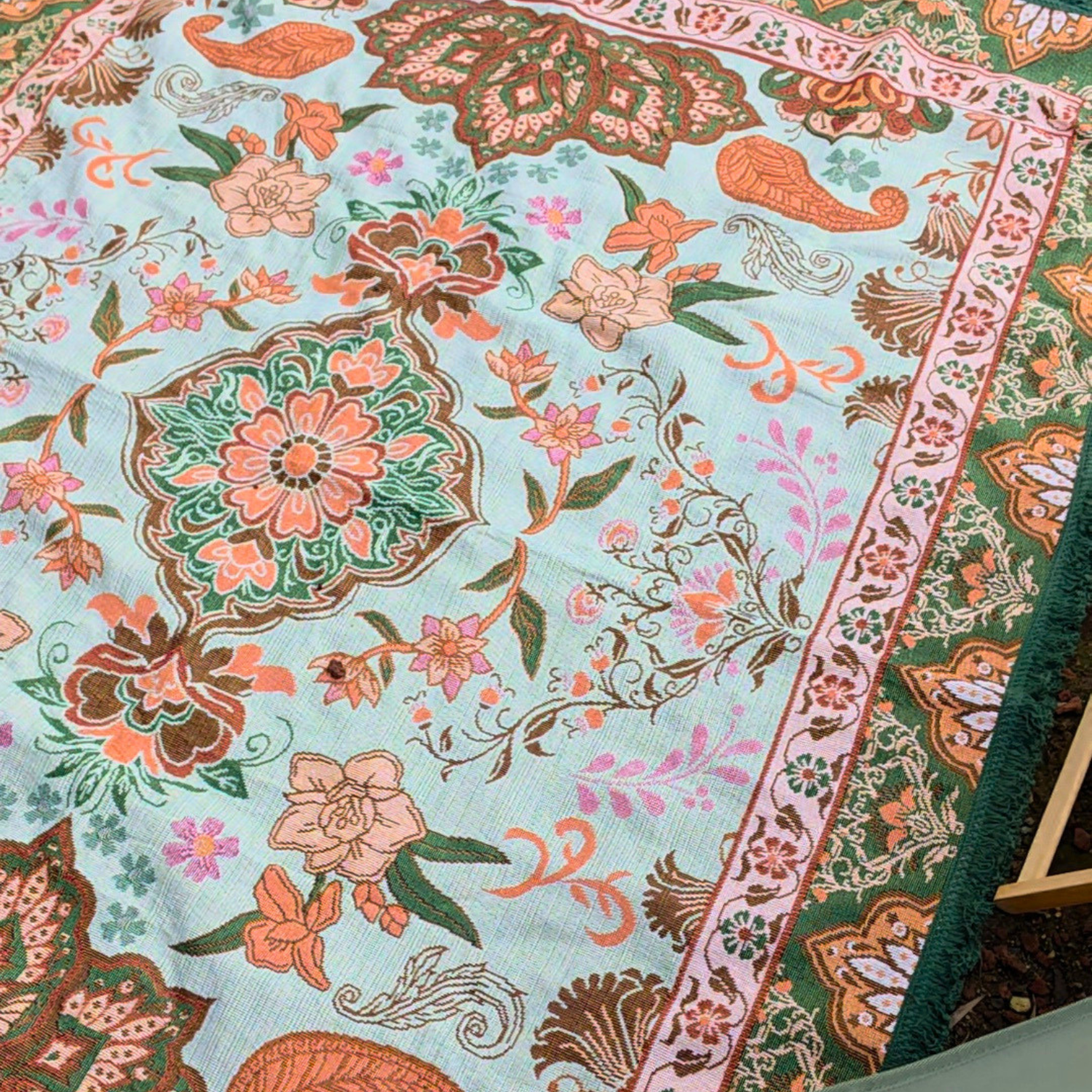 Detailed view of the Vanaway Willow woven travel throw rug highlighting its soft blue, sage green, cream and terracotta botanical design, intricate woven texture and premium craftsmanship.